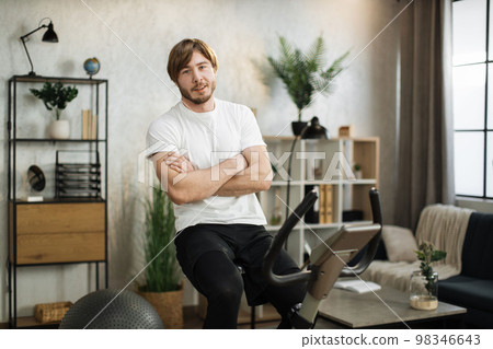 Sports bearded caucasian man in sportswear sitting with crossed hands cycling bike 98346643