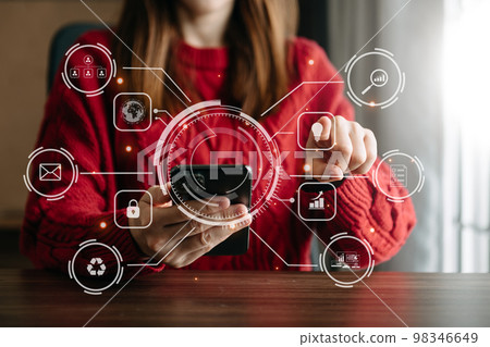 businesswoman working with laptop computer and smart phone on desk in modern office with virtual icon diagram. 98346649