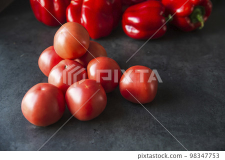 red tomatoes on a dark kitchen counter red tomatoes on a dark kitchen counter 98347753