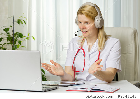 Online consultation doctor Virtual doctor visit telemedicine concept giving advice over laptop 98349143