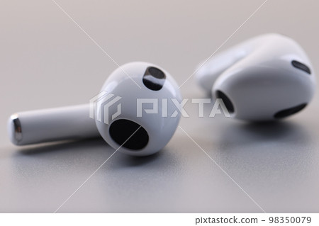 White headphones wireless headphones on gray background. 98350079