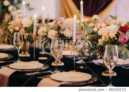 Beautiful table setting with floral decor for a holiday Beautiful table setting with floral decor for a holiday 98350215