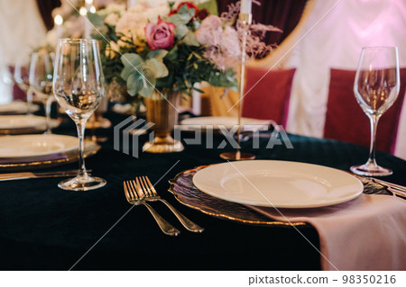 Beautiful table setting with floral decor for a holiday Beautiful table setting with floral decor for a holiday 98350216