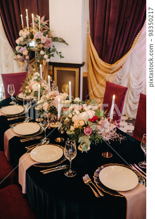 Beautiful table setting with floral decor for a holiday Beautiful table setting with floral decor for a holiday 98350217