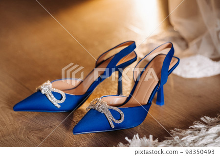Blue summer women's shoes lying on the floor. Festive high-heeled shoes Blue summer women's shoes lying on the floor. Festive high-heeled shoes 98350493