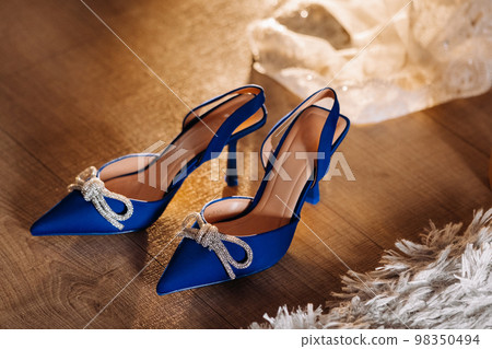 Blue summer women's shoes lying on the floor. Festive high-heeled shoes 98350494