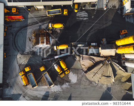 Top down view at a construction site company base with yellow heavy machinery Top down view at a construction site company base with yellow heavy machinery 98351644