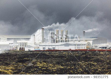 Stem rolling out of the chimneys of a geothermal power plant on a stormy day in Iceland Stem rolling out of the chimneys of a geothermal power plant on a stormy day in Iceland 98351775
