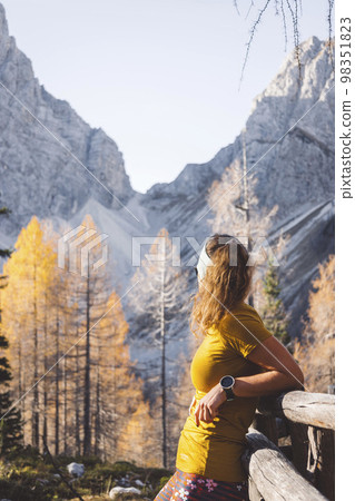 Waist up unrecognizable woman hiker enjoying the mountain sun on a warm autumn day Waist up unrecognizable woman hiker enjoying the mountain sun on a warm autumn day 98351823