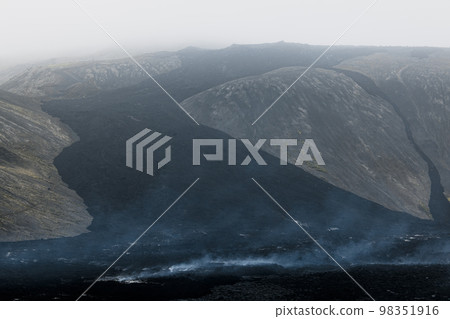 Aerial view of black lava rocks still hot from recent Meradalir eruption in 2022 - Iceland Aerial view of black lava rocks still hot from recent Meradalir eruption in 2022 - Iceland 98351916