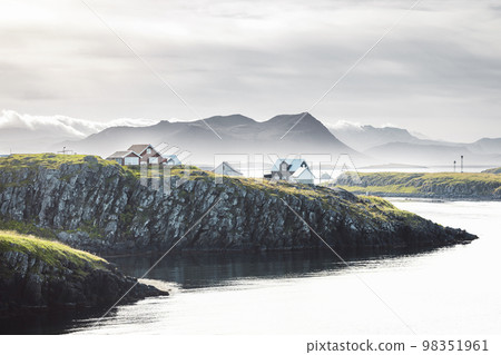 Fog over the sea at town of Stykkisholmskirkja in Iceland, colorful houses on the edge of the cliff Fog over the sea at town of Stykkisholmskirkja in Iceland, colorful houses on the edge of the cliff 98351961