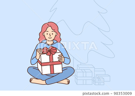 Happy girl with Christmas gifts near fir tree Happy girl with Christmas gifts near fir tree 98353009