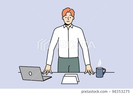 Smiling confident businessman at workplace  98353275