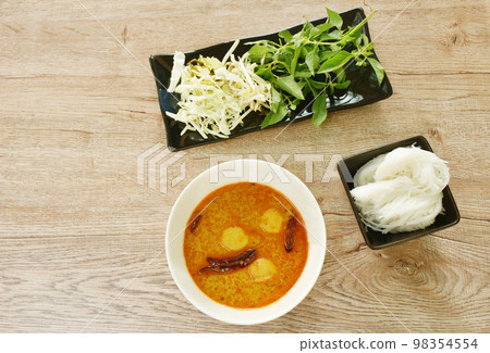 rice noodles on bowl with spicy fish curry sauce and fresh vegetable rice noodles on bowl with spicy fish curry sauce and fresh vegetable 98354554