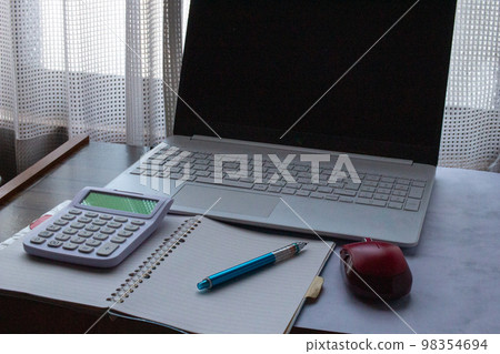 Saving image of keeping a household account book on a computer indoors Saving image of keeping a household account book on a computer indoors 98354694