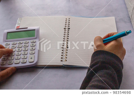 Saving image of keeping a household account book indoors 98354698