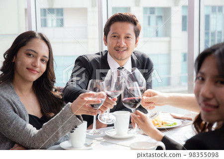 Happiness team young business people in party celebrate success holding glass of wine cheer. Happiness team young business people in party celebrate success holding glass of wine cheer. 98355098