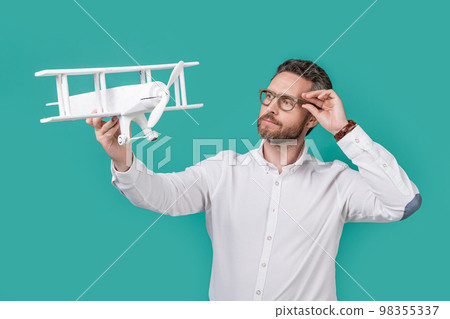 ambitious man launch aspirations with plane. photo of man launch aspirations with toy plane 98355337