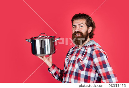 mature handsome man in checkered shirt hold pan for cooking food, dinner mature handsome man in checkered shirt hold pan for cooking food, dinner 98355453