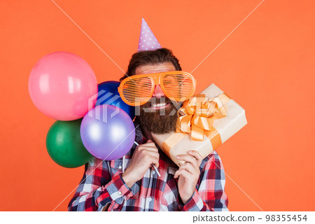 Having crazy day. summer shopping sales. feel the happiness. happy man with beard. man in party glasses hold balloons. holiday celebration. happy birthday to you. corporate party celebrate 98355454