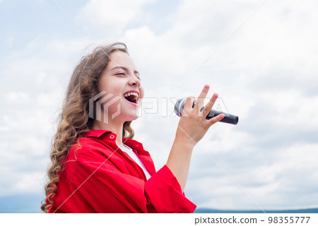 She is really cute. karaoke club. music is my life. kid sing with mic. cheerful event manager. child have fun on party. happy singer with microphone. classic cool. girl singing. vocal school concept She is really cute. karaoke club. music is my life. kid sing with mic. cheerful event manager. child have fun on party. happy singer with microphone. classic cool. girl singing. vocal school concept 98355777