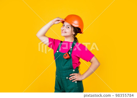 hello. Little girl using a measuring tape. construction worker with tape measure. Cute kid as a construction worker. kid repairing home. happy childhood. self-retracting metal tape measure 98355784