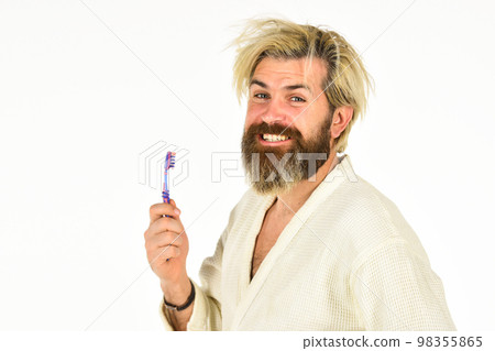 Morning inspiration. good morning. male health care and personal hygiene. time to relax. brutal bearded hipster isolated on white. feeling happy in bathroom. man in bathrobe brush his teeth 98355865