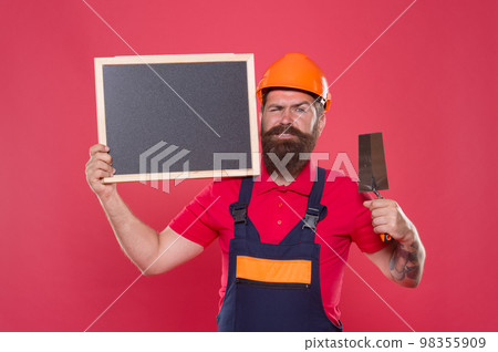 Dreams come true. Skillful plasterer. Successful renovation. Bearded man worker with plastering tool. Plasterer hipster builder in hard hat hold blackboard copy space. Professional plasterer 98355909