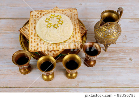 Celebration Matzah and kiddush is Jewish holiday involving matzoh four cups red kosher wine for Passover. Celebration Matzah and kiddush is Jewish holiday involving matzoh four cups red kosher wine for Passover. 98356785