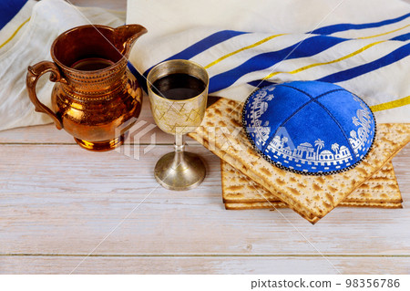 In celebration composition Jewish holiday Pesach cup of kosher kiddush wine unleavened bread matzah In celebration composition Jewish holiday Pesach cup of kosher kiddush wine unleavened bread matzah 98356786