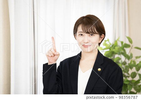 A female lawyer smiling with her index finger up 98356787