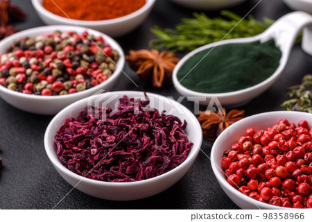 Composition consisting of a variation of several types of spices in white ceramic bowls Composition consisting of a variation of several types of spices in white ceramic bowls 98358966