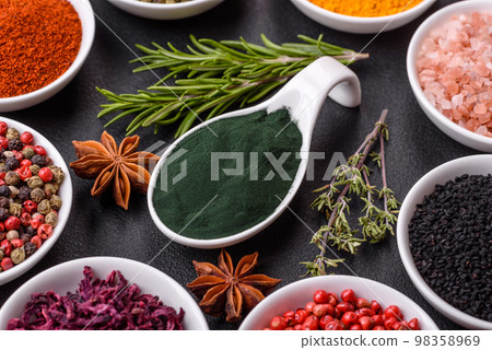 Composition consisting of a variation of several types of spices in white ceramic bowls Composition consisting of a variation of several types of spices in white ceramic bowls 98358969