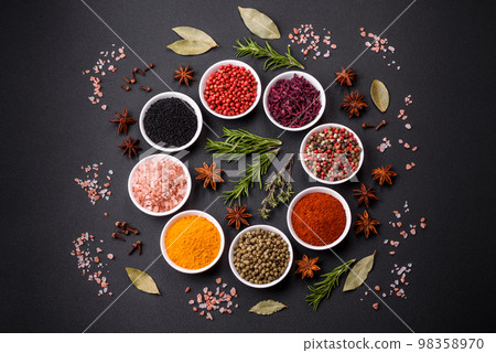 Composition consisting of a variation of several types of spices in white ceramic bowls Composition consisting of a variation of several types of spices in white ceramic bowls 98358970