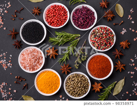 Composition consisting of a variation of several types of spices in white ceramic bowls Composition consisting of a variation of several types of spices in white ceramic bowls 98358971