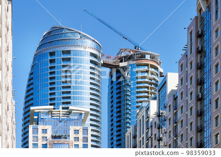 Construction of modern residential skyscrapers with smooth lines of facades. 98359033