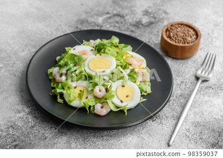 Delicious fresh healthy salad with shrimp, egg, lettuce and flax seeds Delicious fresh healthy salad with shrimp, egg, lettuce and flax seeds 98359037