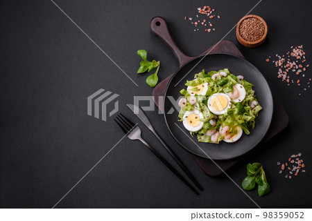 Delicious fresh healthy salad with shrimp, egg, lettuce and flax seeds 98359052