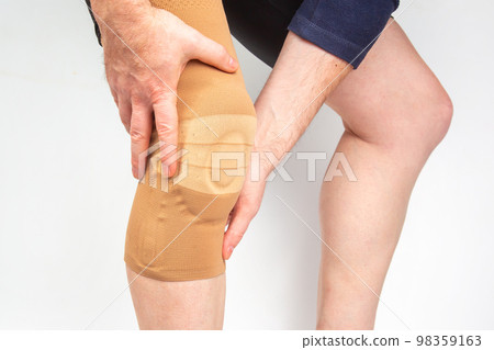 bandage for fixing the injured knee of the human leg on a white background. 98359163