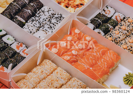 Various rolls in boxes. Food delivery Japanese cuisine. 98360124