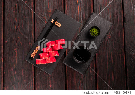 California sushi roll with salmon, avocado cucumber and tobiko caviar served on black board top view - Japanese food 98360471