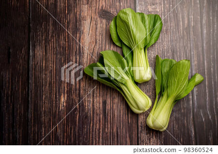Celery cabbage or peach choi, asian baby salad leaves on wooden background, copy space 98360524