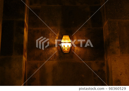 Antique iron lantern on stone building 98360529