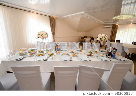 Festive table set with food and drinks. 98360833