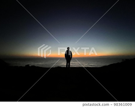 A man standing at the transition from dusk to night in Palos Verdes 98361009