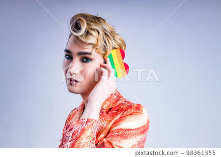 Closeup portrait of a young man with a lipstick over white background 98361355