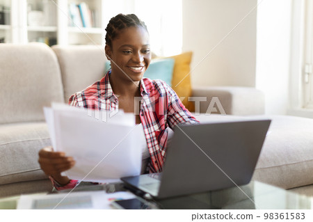 Happy pretty black lady entrepreneur working from home Happy pretty black lady entrepreneur working from home 98361583