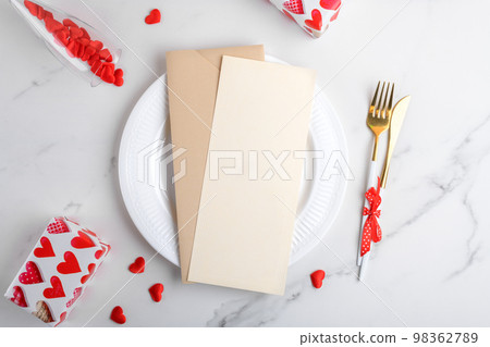 Vertical menu card mockup with festive Valentines day, plate, red hearts, gifts on white marble background, top view 98362789