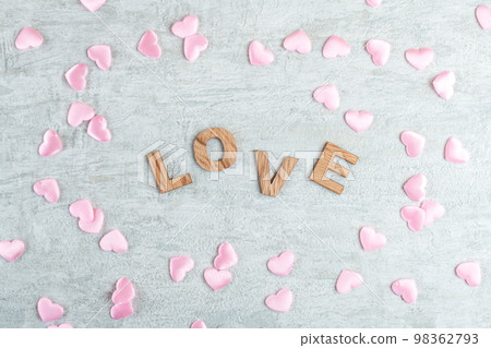 The word love in wooden letters on a light grey background with little pink hearts, flat lay, top view The word love in wooden letters on a light grey background with little pink hearts, flat lay, top view 98362793