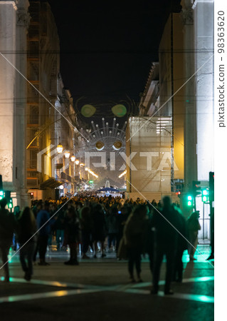 People walk along lisbon's decorated main street People walk along lisbon's decorated main street 98363620